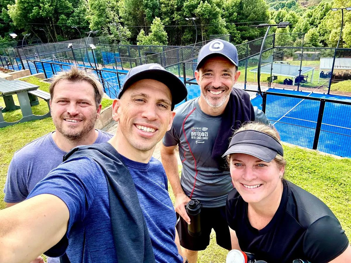 Four Codeo team members taking a selfie after a game of padel